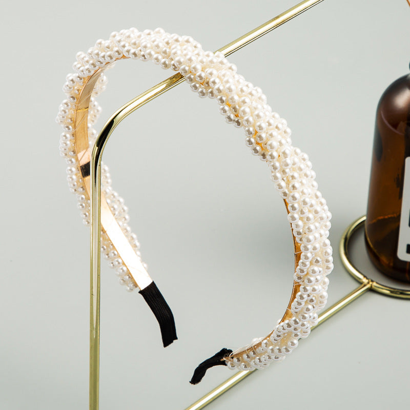 The Korean version is fashionable and beautiful, full of pearl headbands, and the girl is super immortal, and the headband temperament is versatile, and the European and American simple headbands are used