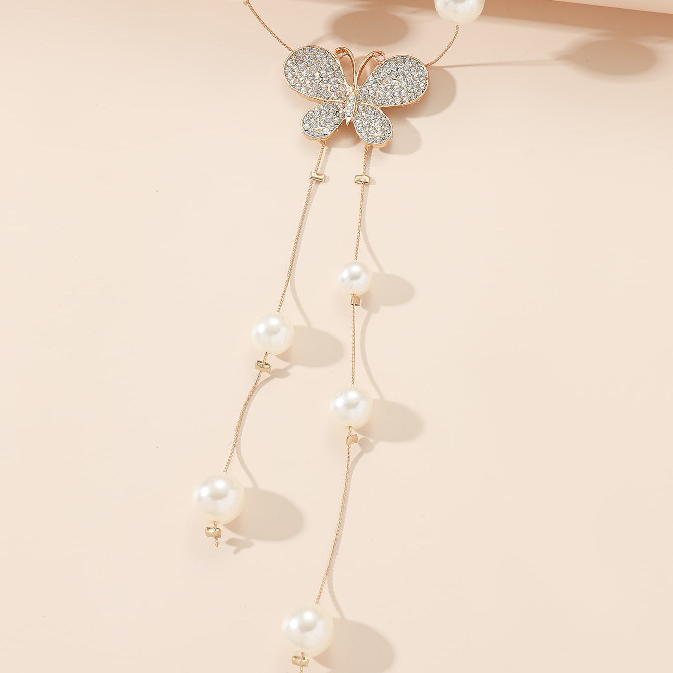 The new super fairy temperament pearl necklace is a niche long tassel, simple and versatile, butterfly petal sweater chain